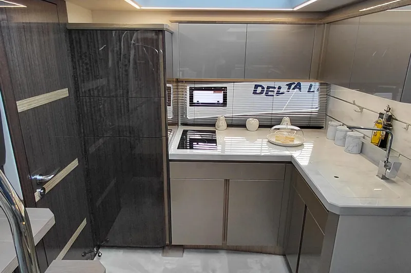 Huge Specifications Yacht Photos Pics Modern kitchen interior of 2023 Galeon 405 HTS yacht, featuring sleek cabinetry and appliances.
