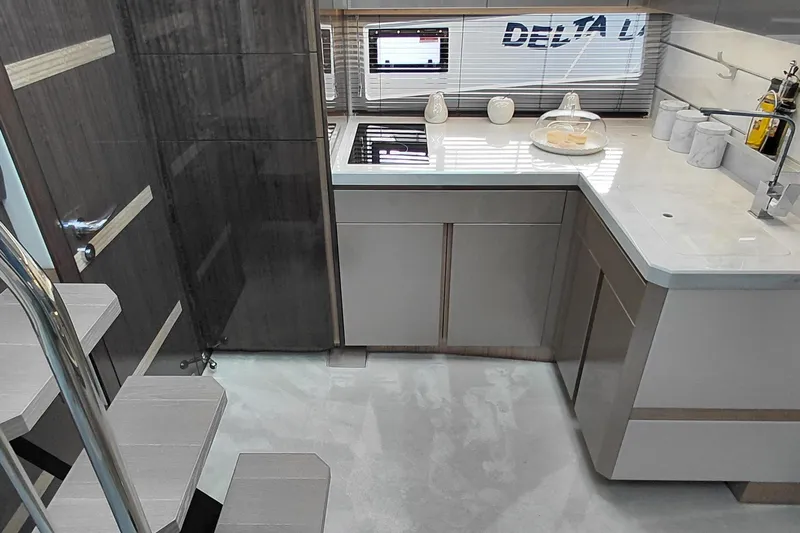 Huge Specifications Yacht Photos Pics Modern kitchen interior of 2023 Galeon 405 HTS yacht, featuring sleek cabinetry and appliances.