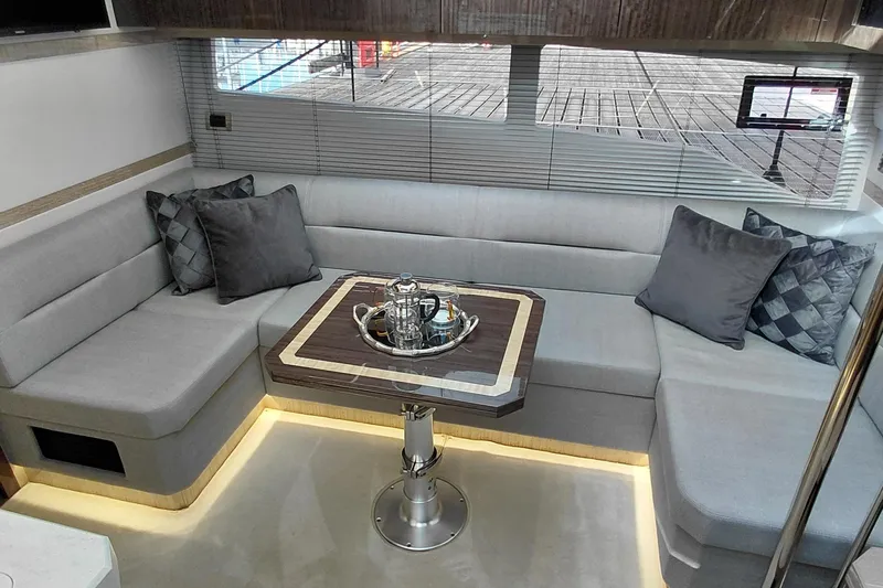 Huge Specifications Yacht Photos Pics Luxurious interior of 2023 Galeon 405 HTS yacht with elegant seating and table.