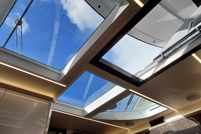 Huge Specifications Yacht Photos Pics 2023 Galeon 405 HTS yacht interior with panoramic sunroof and blue sky view.