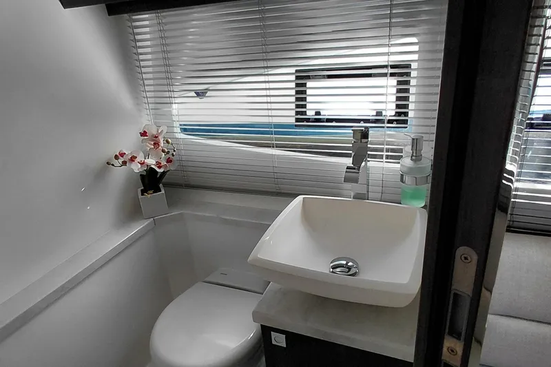 Huge Specifications Yacht Photos Pics Modern bathroom interior of 2023 Galeon 405 HTS yacht with sink and floral decor.
