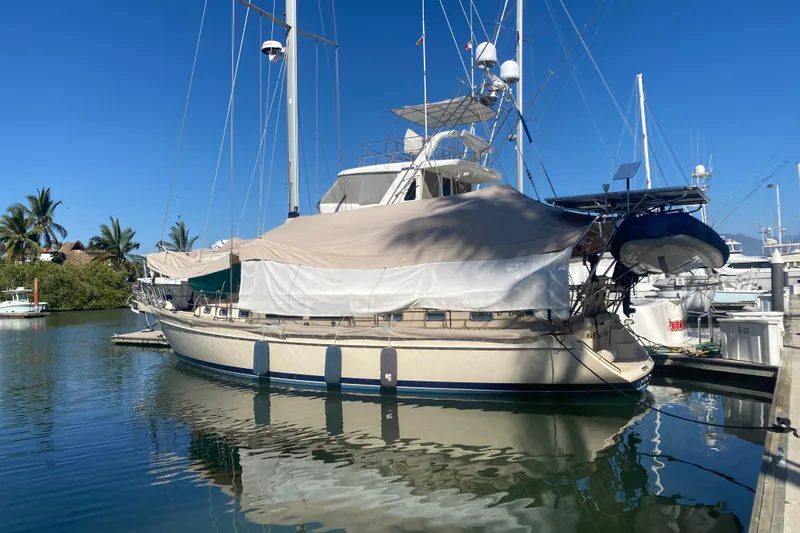 Make Me Laugh Again Yacht Photos Pics 2005 Island Packet 445 sailboat docked in a marina under clear blue skies.