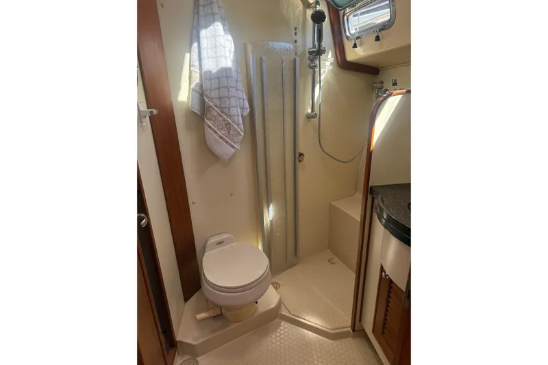 Make Me Laugh Again Yacht Photos Pics Bathroom interior of 2005 Island Packet 445 yacht, featuring shower and toilet.