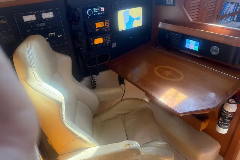 Make Me Laugh Again Yacht Photos Pics Navigation station of 2005 Island Packet 445 yacht with leather chair and control panels.