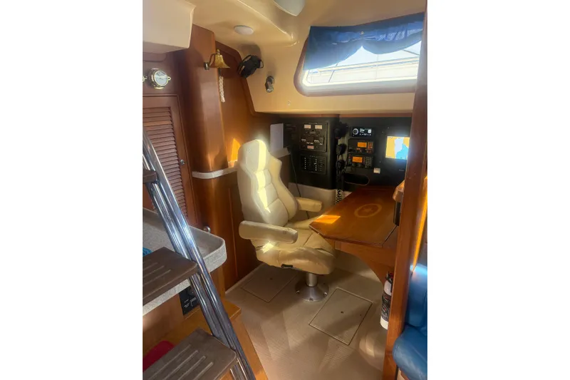 Make Me Laugh Again Yacht Photos Pics Interior of 2005 Island Packet 445 yacht with navigation station and comfortable seating.
