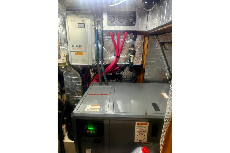 Make Me Laugh Again Yacht Photos Pics Engine room of 2005 Island Packet 445 yacht with electrical components and wiring.