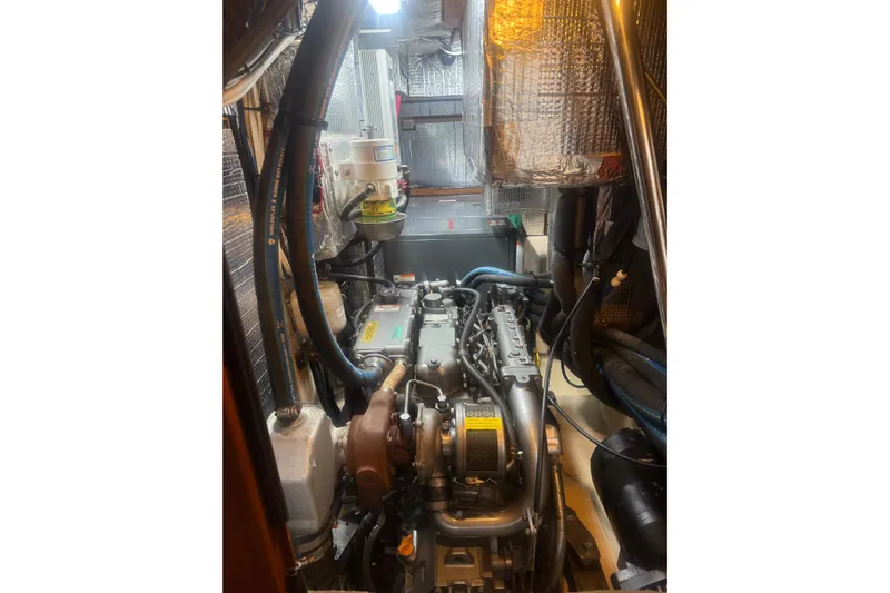 Make Me Laugh Again Yacht Photos Pics Engine room of 2005 Island Packet 445 sailboat, showcasing mechanical components and insulation.