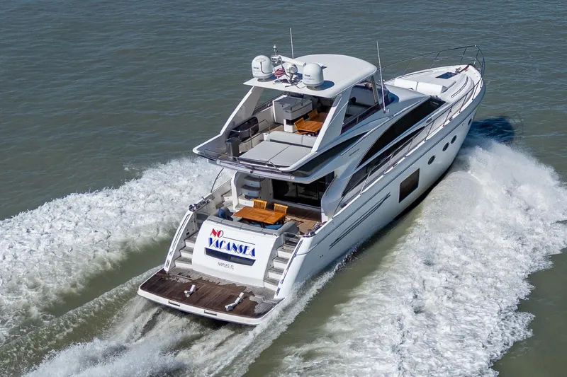 No Vacansea Yacht Photos Pics 2016 Princess Flybridge 64 Motor Yacht cruising on open water, rear view.