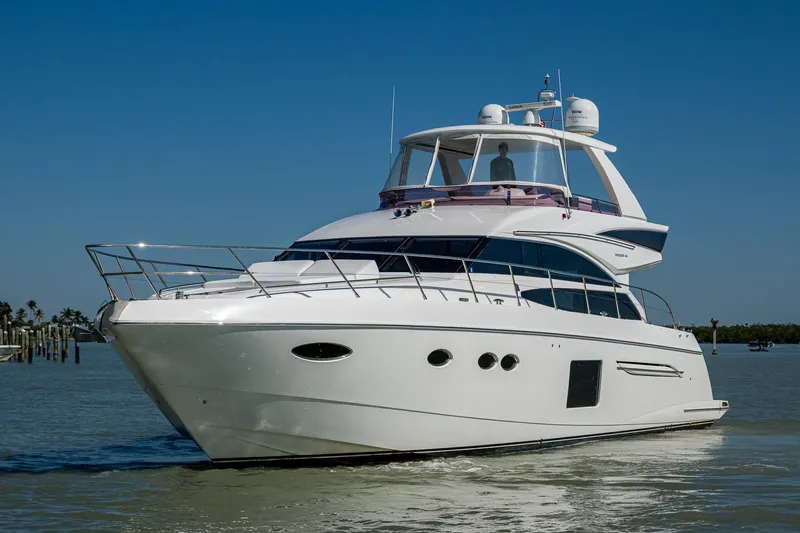 No Vacansea Yacht Photos Pics 2016 Princess Flybridge 64 Motor Yacht cruising on calm waters under clear blue skies.