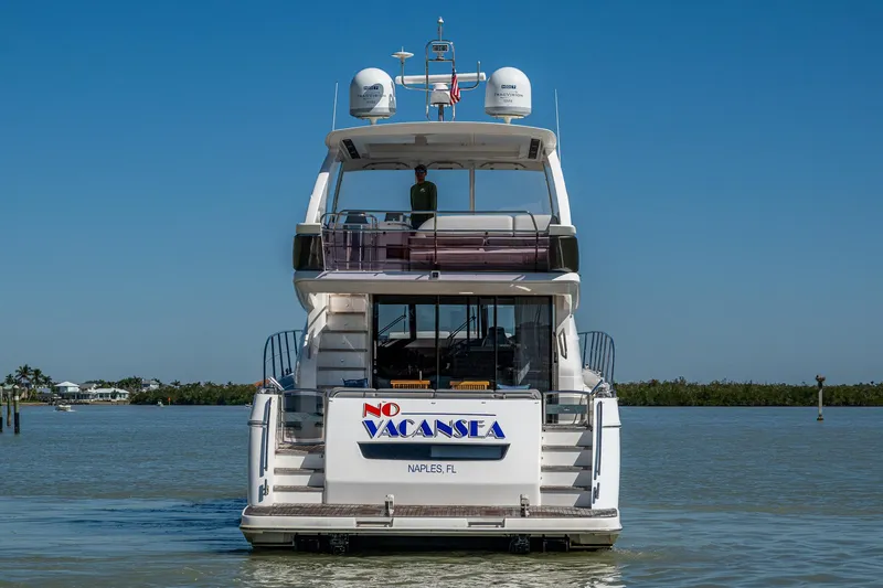 No Vacansea Yacht Photos Pics 2016 Princess Flybridge 64 Motor Yacht on calm water, rear view.