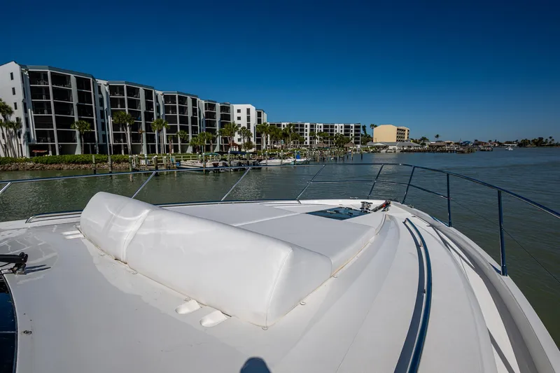 No Vacansea Yacht Photos Pics 2016 Princess Flybridge 64 Motor Yacht docked near waterfront apartments.