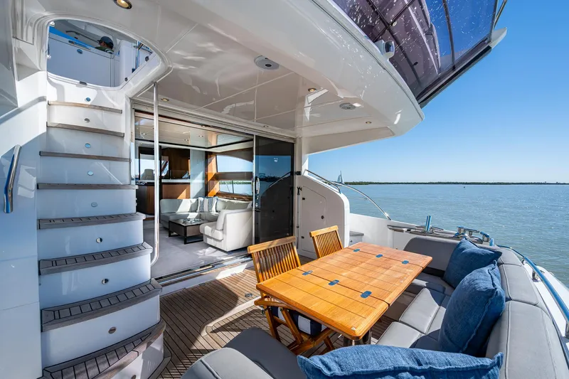 No Vacansea Yacht Photos Pics Luxurious 2016 Princess Flybridge 64 Motor Yacht with elegant outdoor seating and scenic water view.