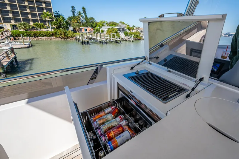 No Vacansea Yacht Photos Pics Outdoor kitchenette on 2016 Princess Flybridge 64 Motor Yacht with drinks and grill.