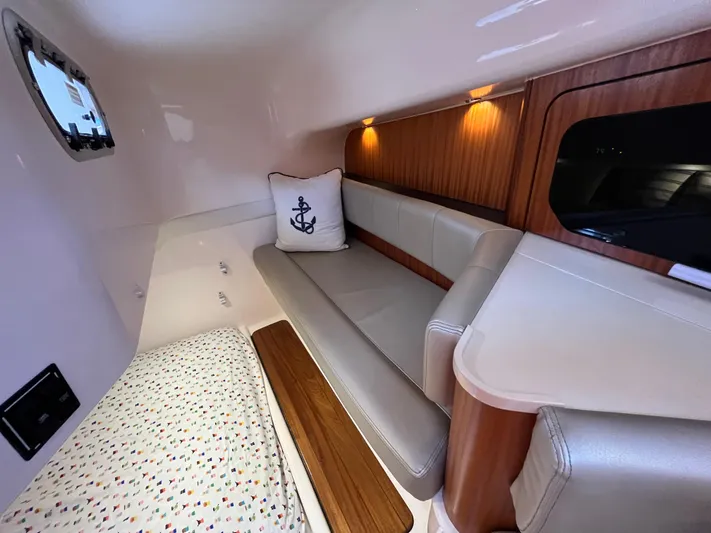Snot Easy Yacht Photos Pics Interior cabin of 2016 Pursuit OS 385 Offshore with bed, sofa, and nautical decor.