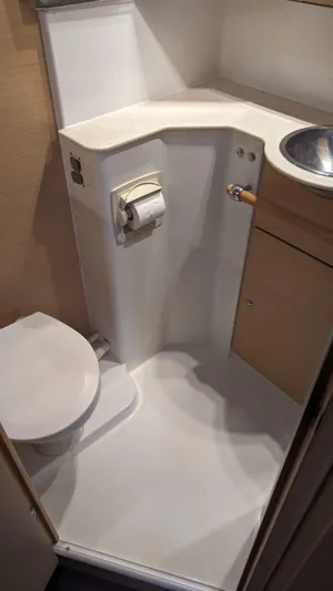 Sandstar Yacht Photos Pics Compact bathroom in 2009 Lagoon 500 yacht with toilet, sink, and storage.