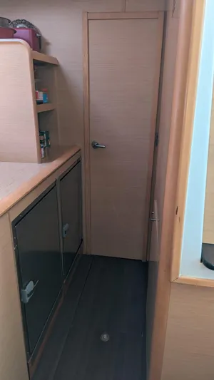 Sandstar Yacht Photos Pics Interior of 2009 Lagoon 500 yacht with wooden cabinetry and storage shelves.