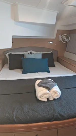 Sandstar Yacht Photos Pics Luxurious cabin interior of 2009 Lagoon 500 yacht with neatly arranged bedding.