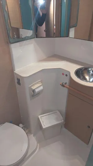 Sandstar Yacht Photos Pics Compact bathroom in 2009 Lagoon 500 yacht with sink and toilet.