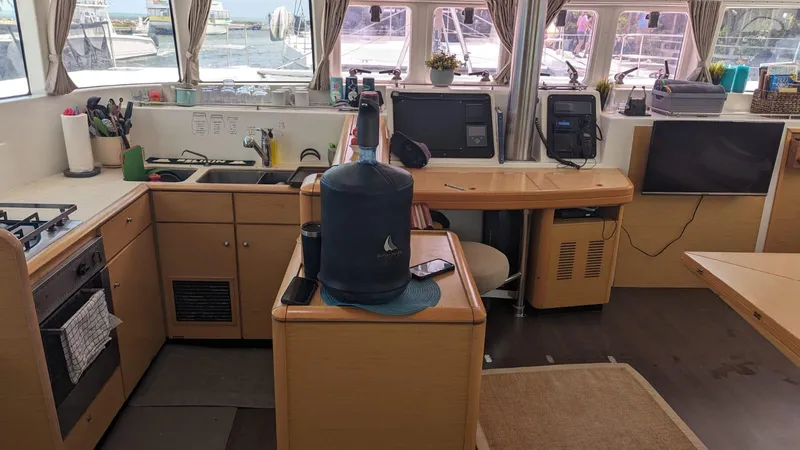 Sandstar Yacht Photos Pics Interior of 2009 Lagoon 500 catamaran kitchen with appliances and navigation equipment.