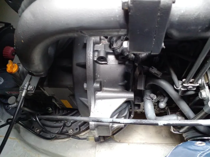 Sandstar Yacht Photos Pics Engine compartment of a 2009 Lagoon 500 catamaran, showcasing mechanical components and wiring.