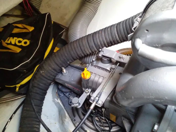 Sandstar Yacht Photos Pics Engine compartment of a 2009 Lagoon 500 catamaran with visible hoses and equipment.