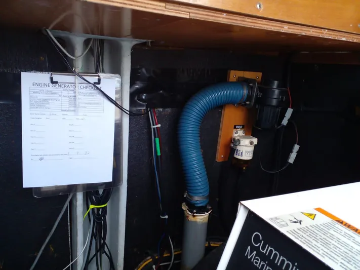 Sandstar Yacht Photos Pics Engine compartment of 2009 Lagoon 500 with Cummins Marine generator and checklist.