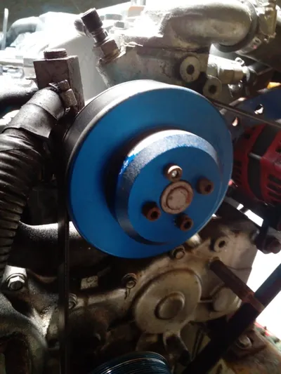 Sandstar Yacht Photos Pics Close-up of a 2009 Lagoon 500 engine component with a blue pulley.