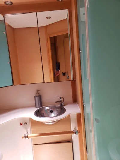 Sandstar Yacht Photos Pics 2009 Lagoon 500 yacht bathroom with modern sink and mirror.