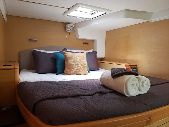 Sandstar Yacht Photos Pics Luxurious cabin interior of 2009 Lagoon 500 yacht with cozy bedding and towels.