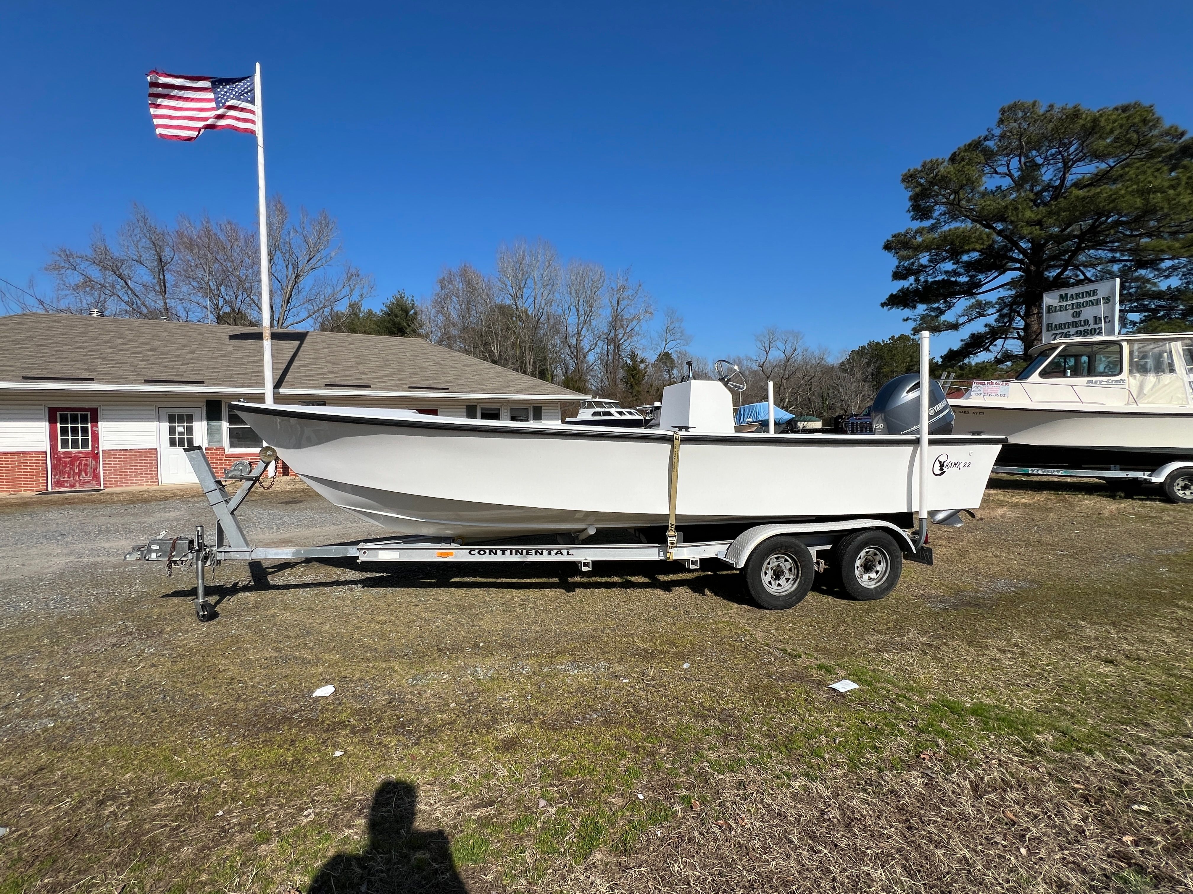 2025 C-Hawk 22 Center Console boat on trailer, blue sky.