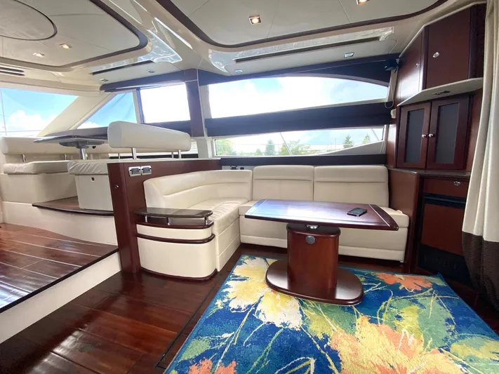 Lucid Dreams Yacht Photos Pics Luxurious interior of 2014 Meridian 441 Sedan yacht with elegant seating and vibrant rug.