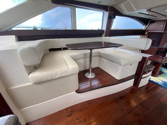Lucid Dreams Yacht Photos Pics Luxurious interior of 2014 Meridian 441 Sedan yacht with elegant seating and wooden flooring.