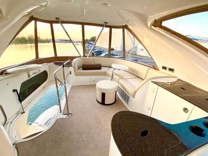 Lucid Dreams Yacht Photos Pics Luxurious interior of 2014 Meridian 441 Sedan yacht with panoramic windows and plush seating.