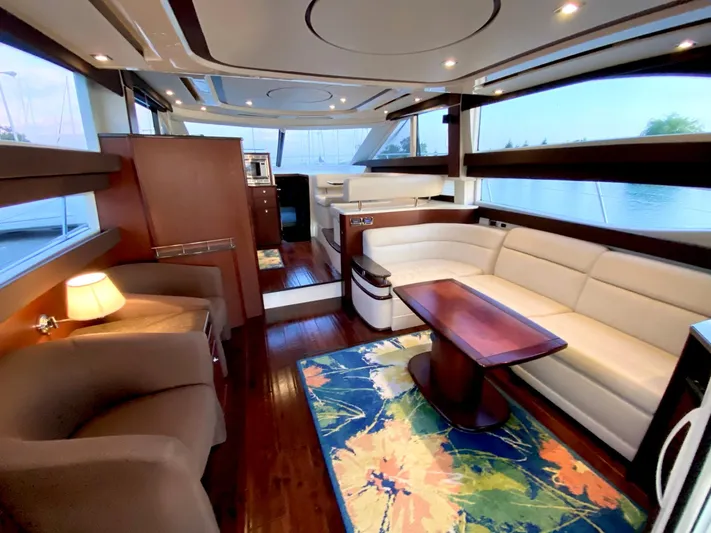 Lucid Dreams Yacht Photos Pics Luxurious interior of a 2014 Meridian 441 Sedan yacht with elegant seating and vibrant rug.
