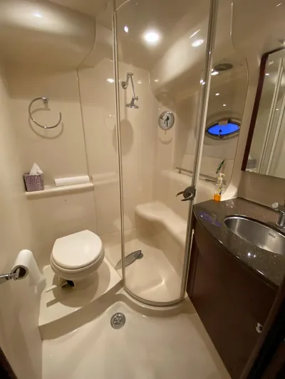 Lucid Dreams Yacht Photos Pics 2014 Meridian 441 Sedan yacht bathroom with shower, toilet, and sink.