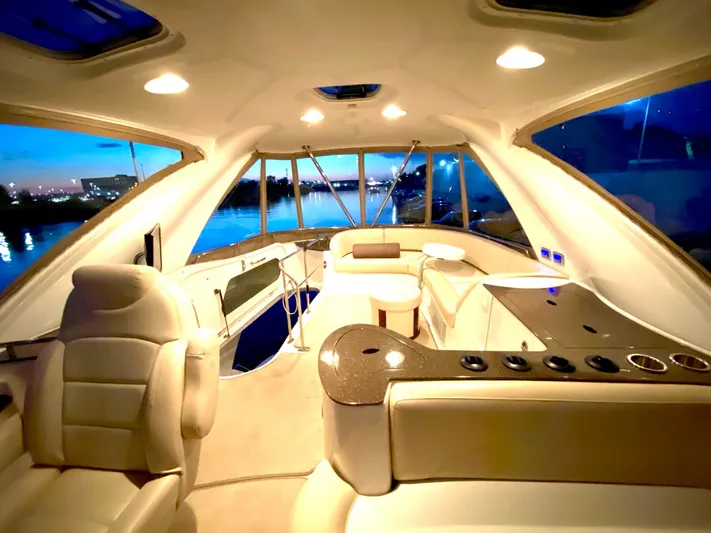 Lucid Dreams Yacht Photos Pics Luxurious interior of a 2014 Meridian 441 Sedan yacht with elegant seating and panoramic windows.