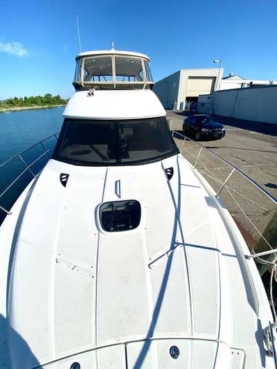 Lucid Dreams Yacht Photos Pics 2014 Meridian 441 Sedan yacht docked at marina under clear blue sky.