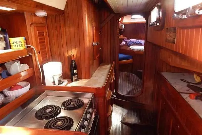 Sacred Space Yacht Photos Pics Cozy 1992 Hans Christian Christina yacht interior with wooden kitchen and sleeping area.