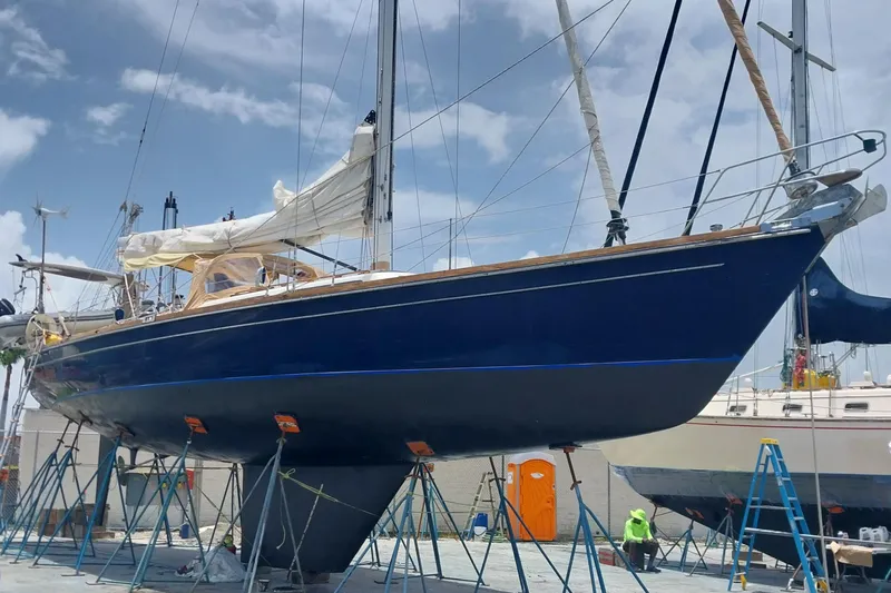 Sacred Space Yacht Photos Pics Sailboat "Christina" by Hans Christian, 1992 model, on dry dock under clear sky.