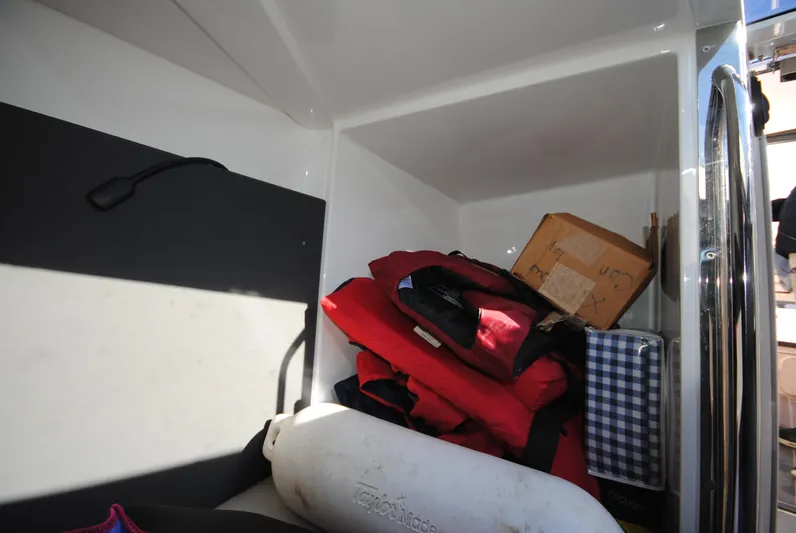  Yacht Photos Pics Storage compartment in a 2015 XO Boats 270 RS with life jackets and equipment.