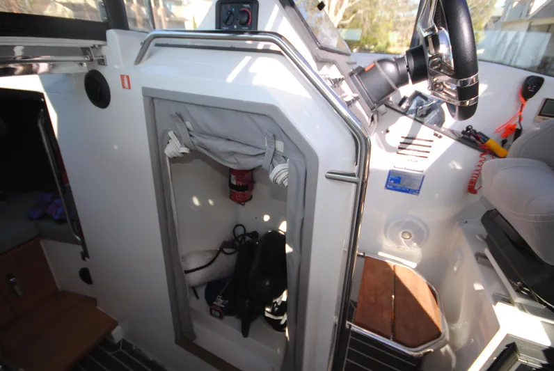  Yacht Photos Pics Interior of 2015 XO Boats 270 RS showing storage compartment and steering wheel.
