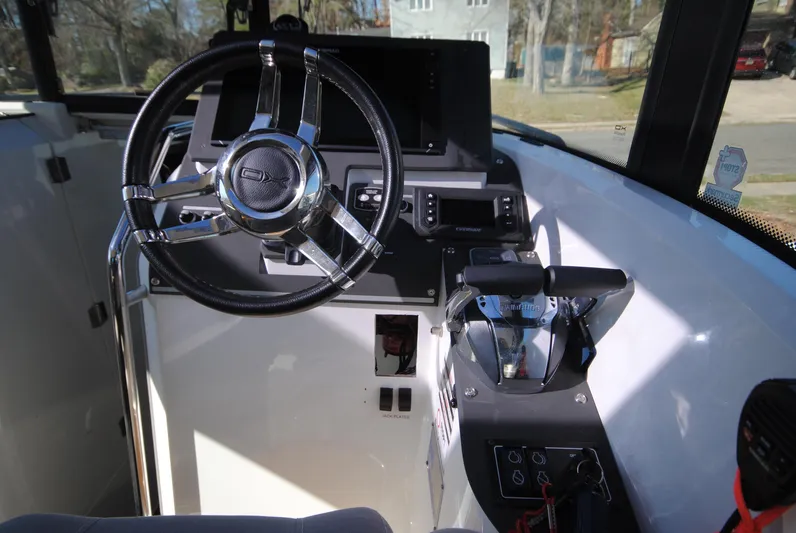  Yacht Photos Pics 2015 XO Boats 270 RS cockpit with steering wheel and control panel.