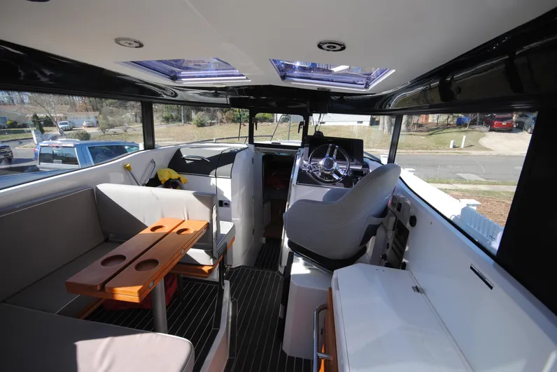  Yacht Photos Pics Interior of 2015 XO Boats 270 RS, featuring seating and helm, with modern design elements.