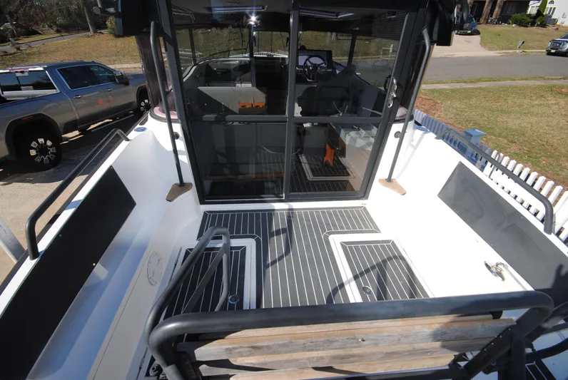  Yacht Photos Pics 2015 XO Boats 270 RS deck view with seating and cabin entrance.