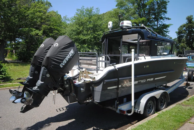  Yacht Photos Pics 2015 XO Boats 270 RS on trailer with dual Evinrude engines, parked outdoors.