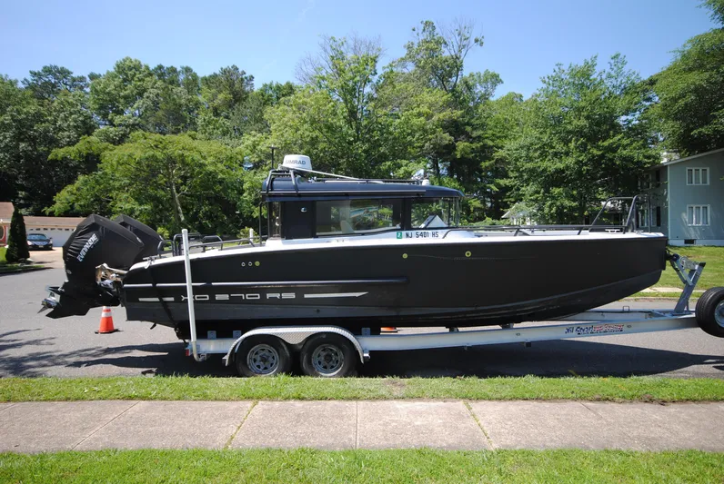  Yacht Photos Pics 2015 XO Boats 270 RS on trailer, parked on suburban street.
