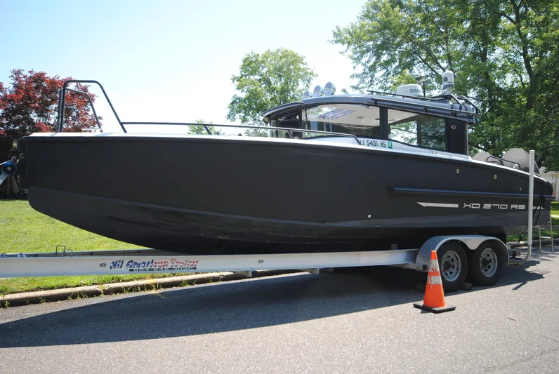  Yacht Photos Pics 2015 XO Boats 270 RS on trailer, parked outdoors with trees in background.