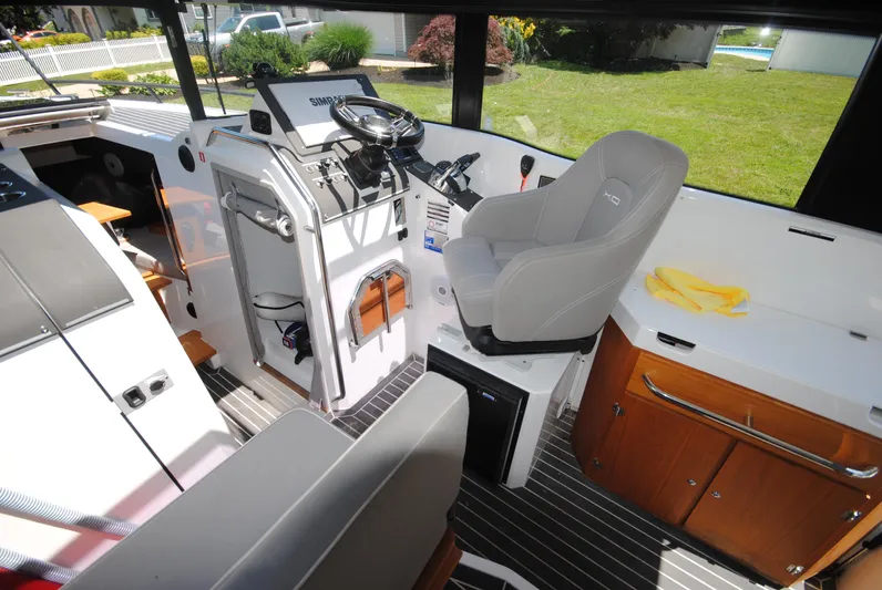  Yacht Photos Pics Interior of 2015 XO Boats 270 RS, featuring helm station and seating area.