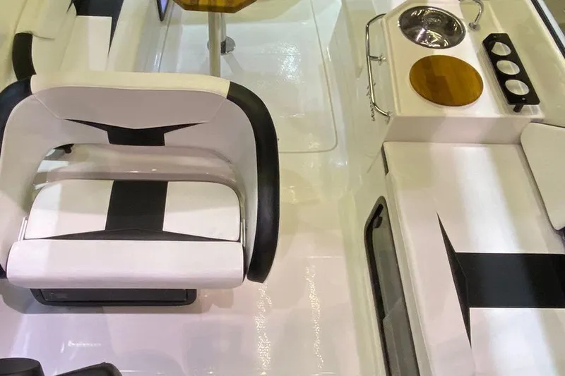  Yacht Photos Pics Interior of 2025 Hanover 305 boat featuring seating and compact kitchenette area.