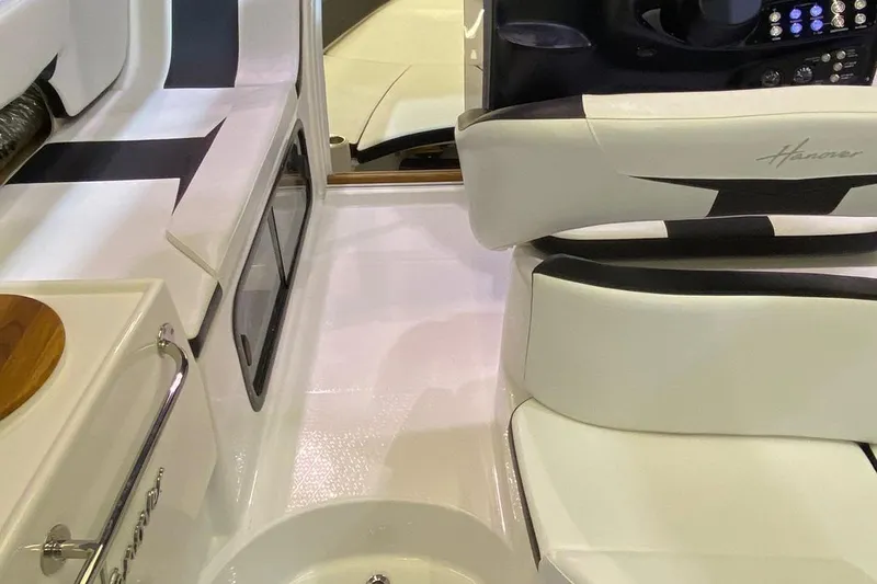  Yacht Photos Pics Interior of 2025 Hanover 305 boat, featuring sleek white seating and modern controls.